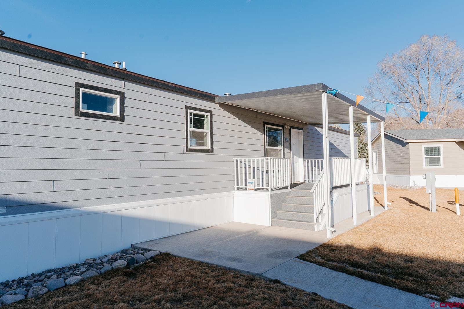 62650 Lasalle Road, Unit 341 Montrose, CO 81403 - Photo 3 of 22 a front view of a house with a yard