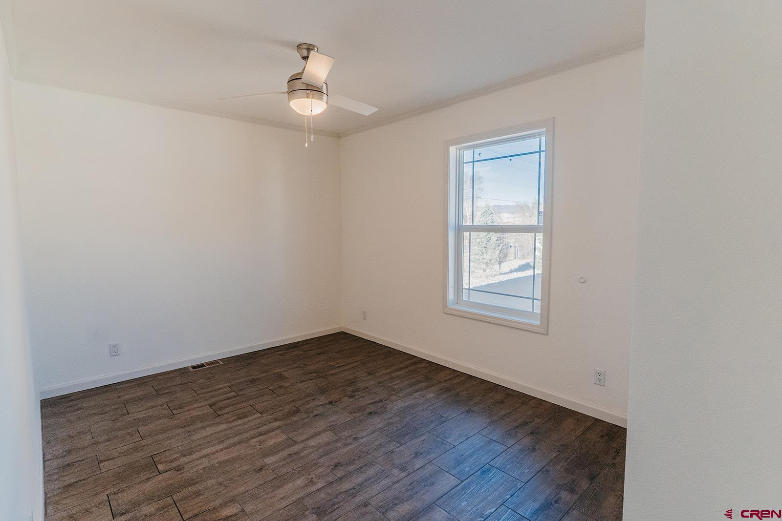62650 Lasalle Road, Unit 341 Montrose, CO 81403 - Photo 7 of 22 a view of an empty room with wooden floor and a window