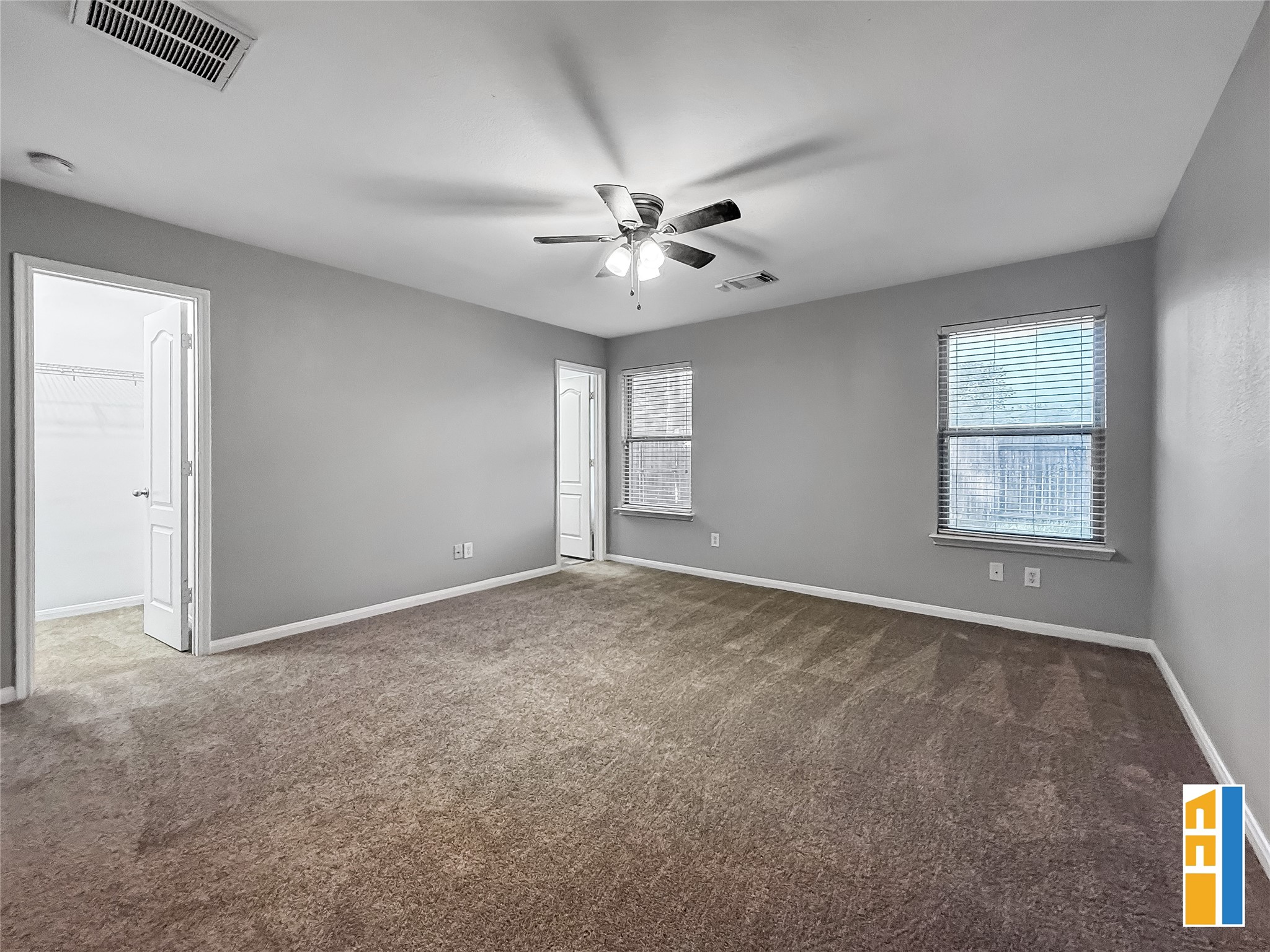 29566 North Legends Bend Drive Spring, TX 77386 - Photo 14 of 21 This spacious primary bedroom features plush carpeting, abundant natural light from dual windows, and a convenient ensuite bathroom, creating a serene retreat within your home.