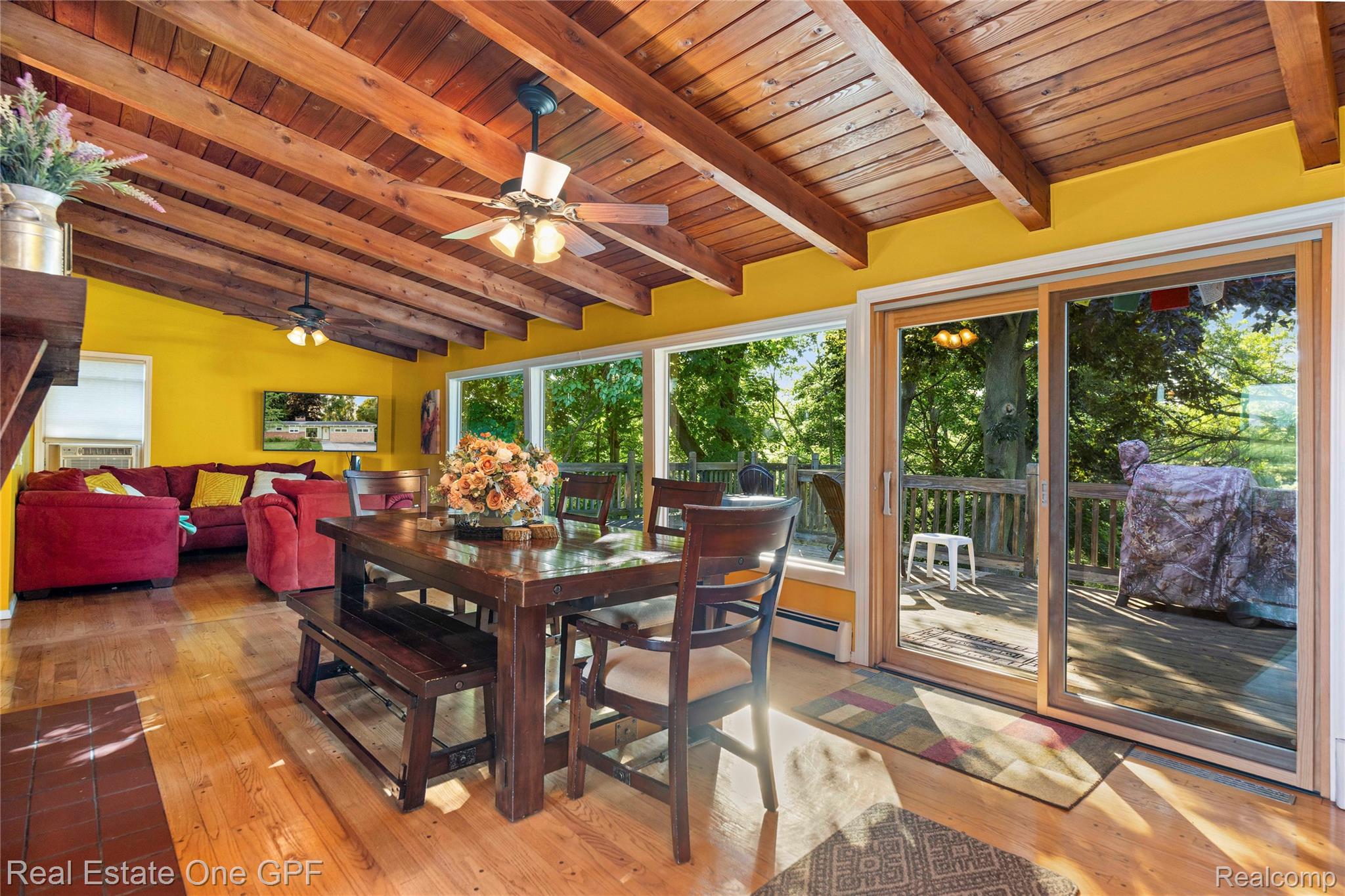 5068 Atkins Road North Street, MI 48049 - Photo 17 of 78 Vaulted wood-beamed ceiling, wood-finish flooring, sliding glass door, recessed lighting, and ceiling fan