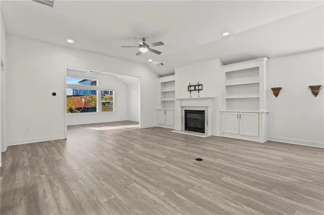 wooden floor fireplace and natural light in a room