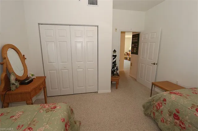 a bedroom with a bed and a chair