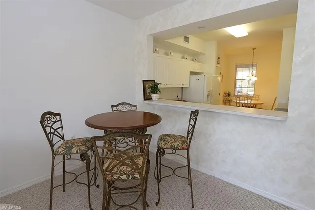 a view of a dining room with furniture and a mirror