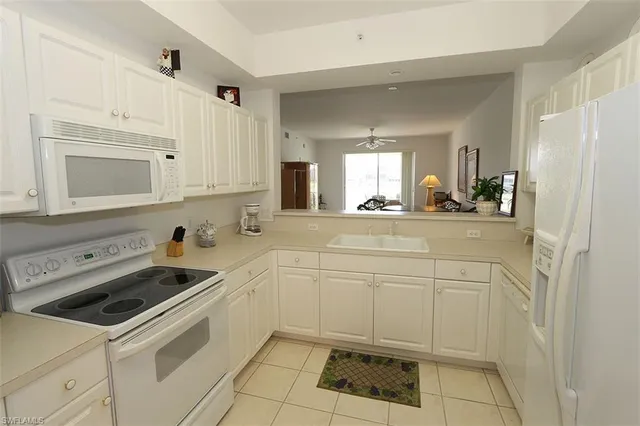 a kitchen with a sink cabinets and appliances