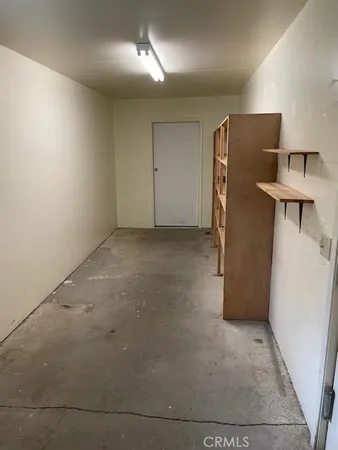 an empty room with a refrigerator