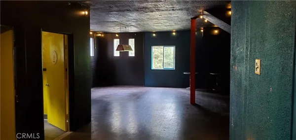 a view of hallway with livingroom and wooden floor