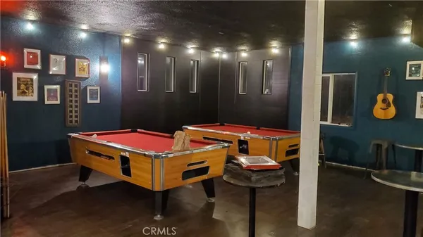 a room with pool table and a chandelier