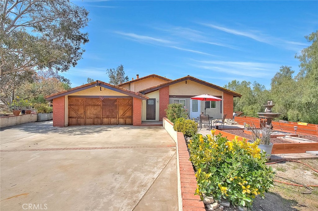 21845 Gold Valley Road Lake Mathews, CA 92570 - Photo 1 of 1 a front view of a house with yard and green space