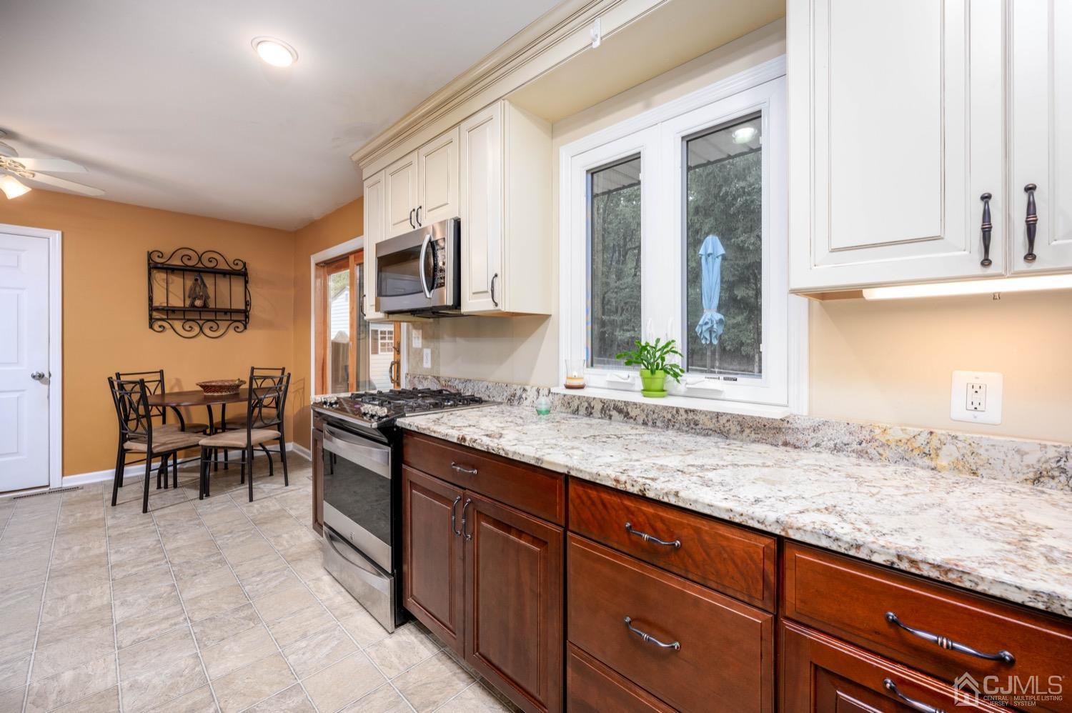 45 Stockton Road Kendall Park, NJ 08824 - Photo 13 of 30 a kitchen with stainless steel appliances granite countertop a stove a sink and a microwave