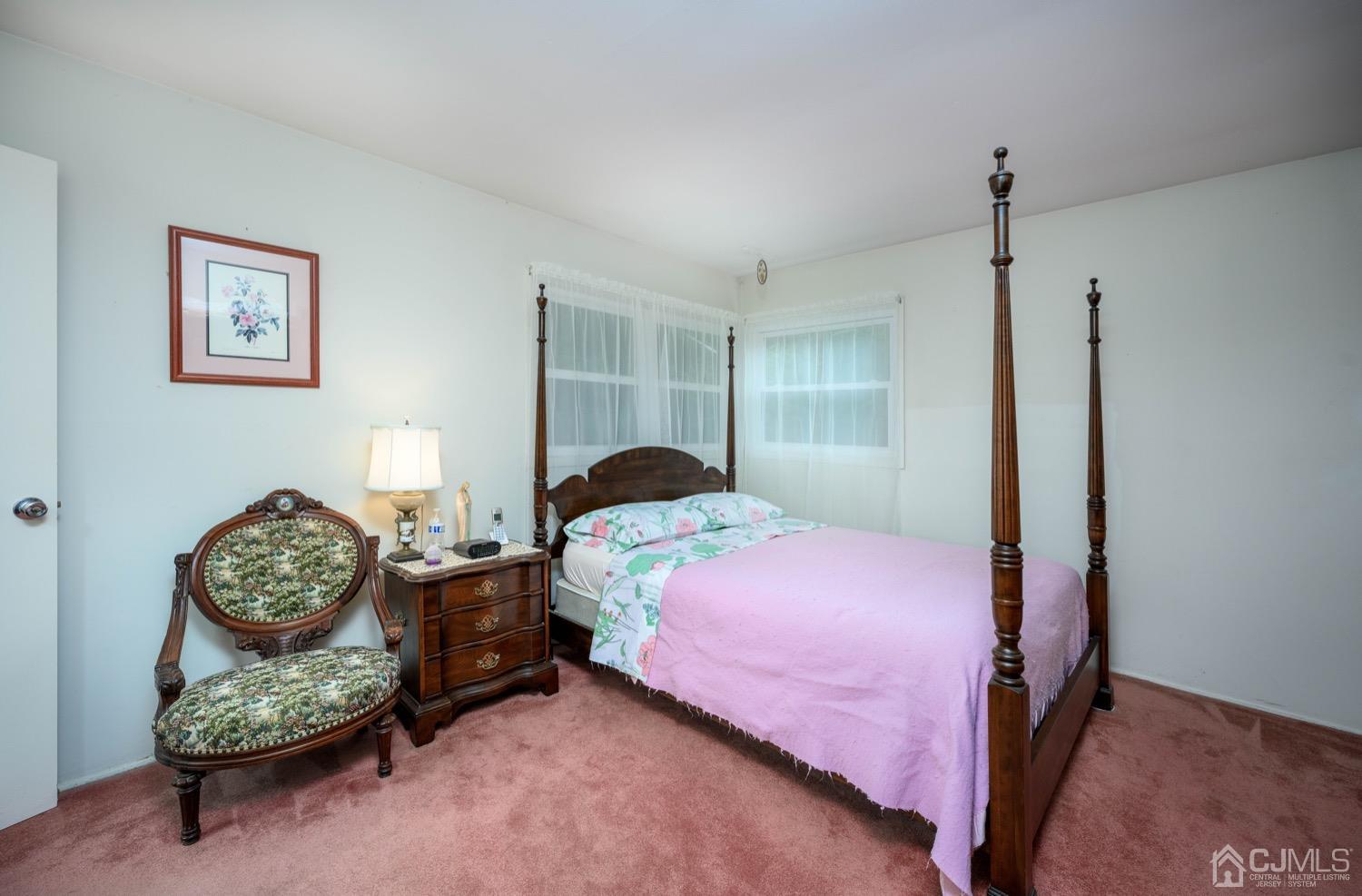 45 Stockton Road Kendall Park, NJ 08824 - Photo 18 of 30 a bedroom with a bed and a chair