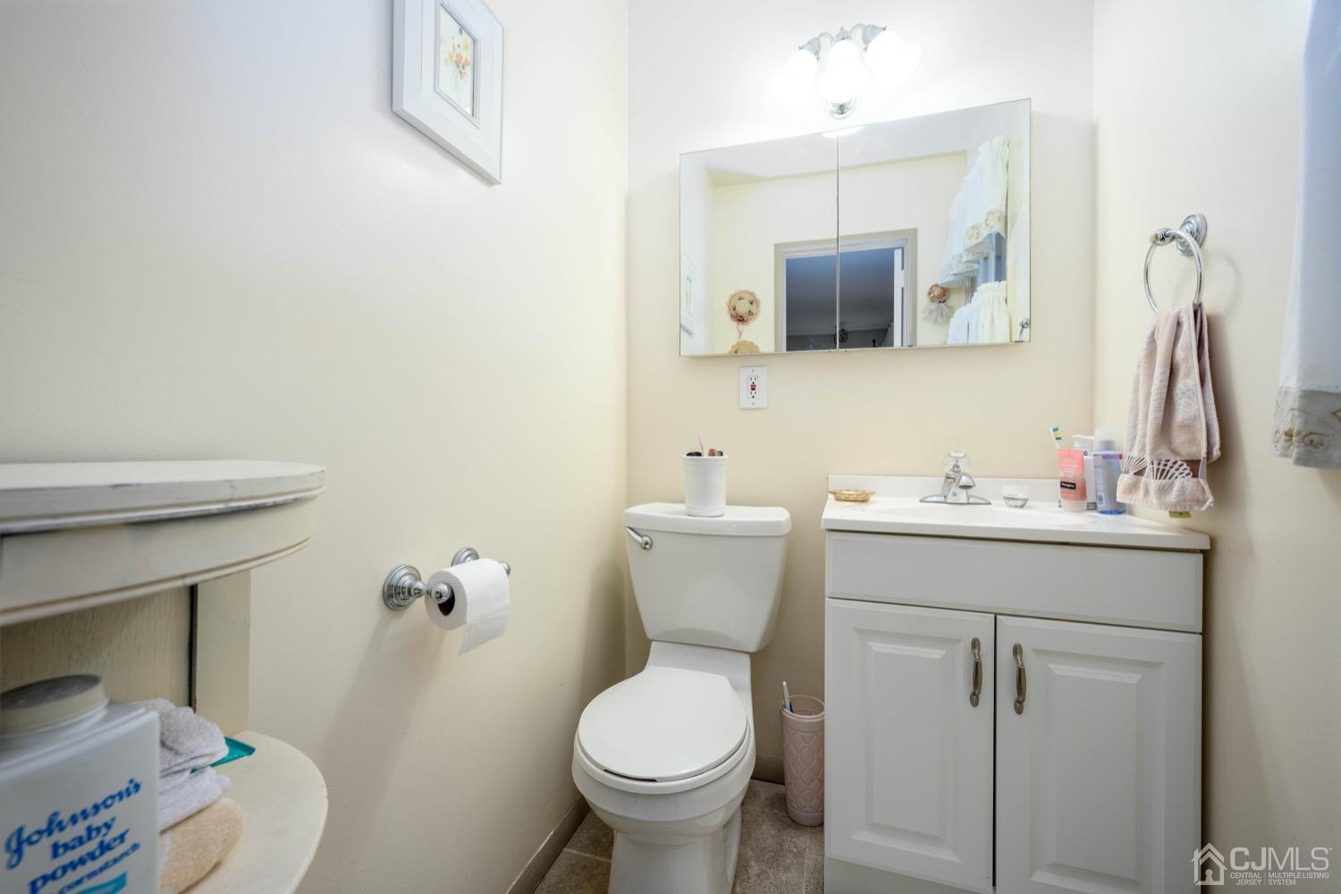 45 Stockton Road Kendall Park, NJ 08824 - Photo 20 of 30 a bathroom with a toilet sink and mirror
