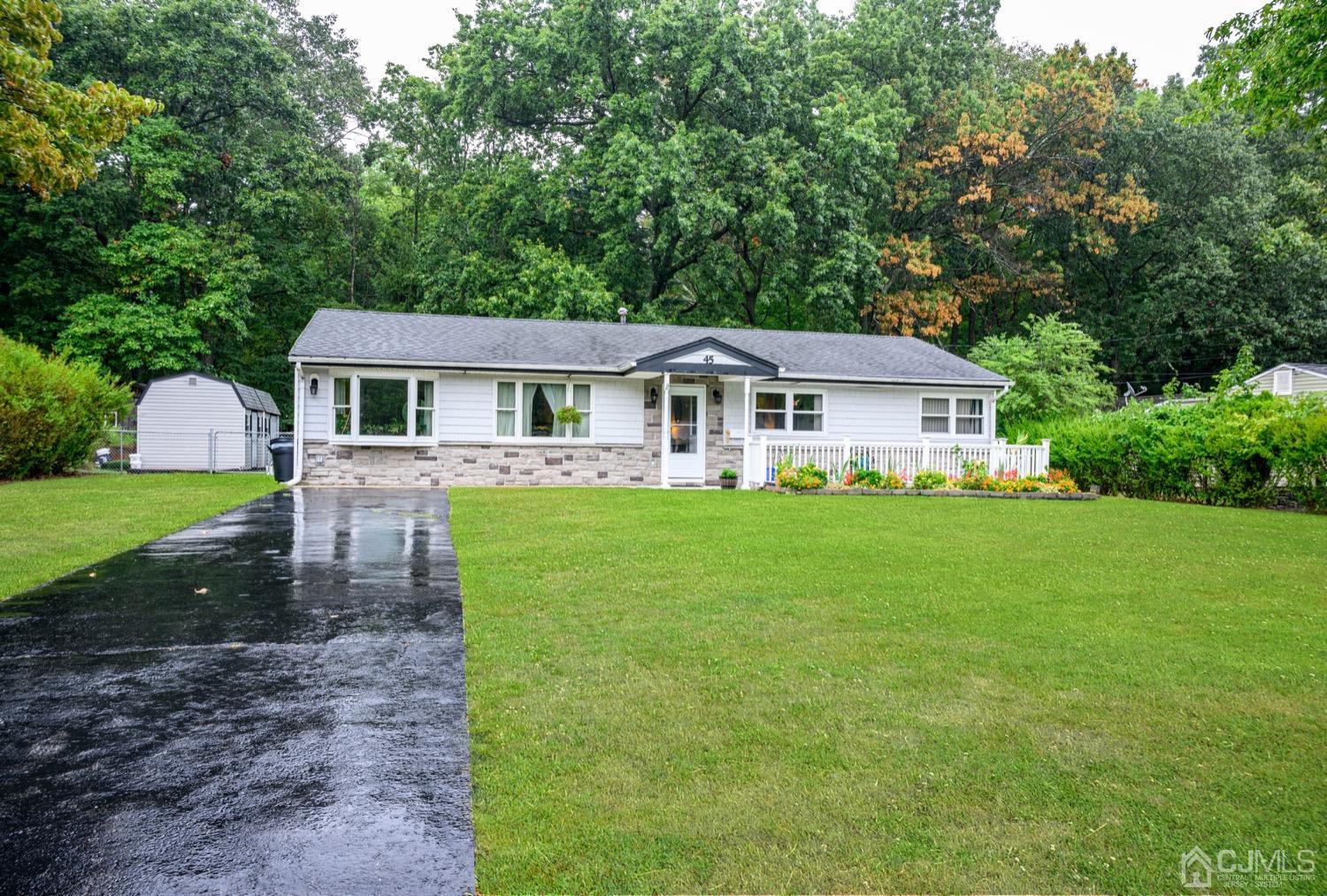 45 Stockton Road Kendall Park, NJ 08824 - Photo 3 of 30 a front view of a house with a yard table and chairs