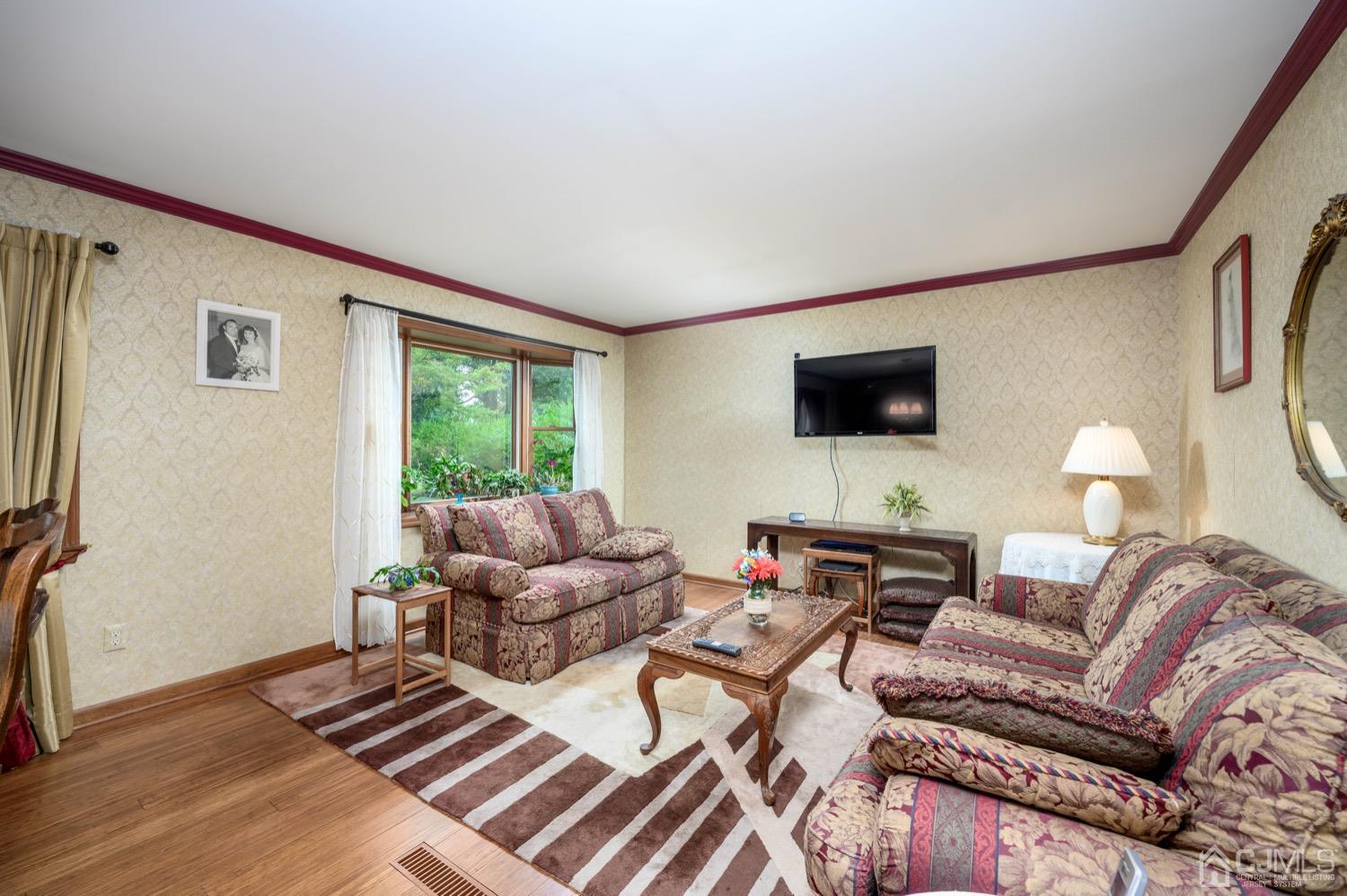 45 Stockton Road Kendall Park, NJ 08824 - Photo 9 of 30 a living room with furniture and a flat screen tv