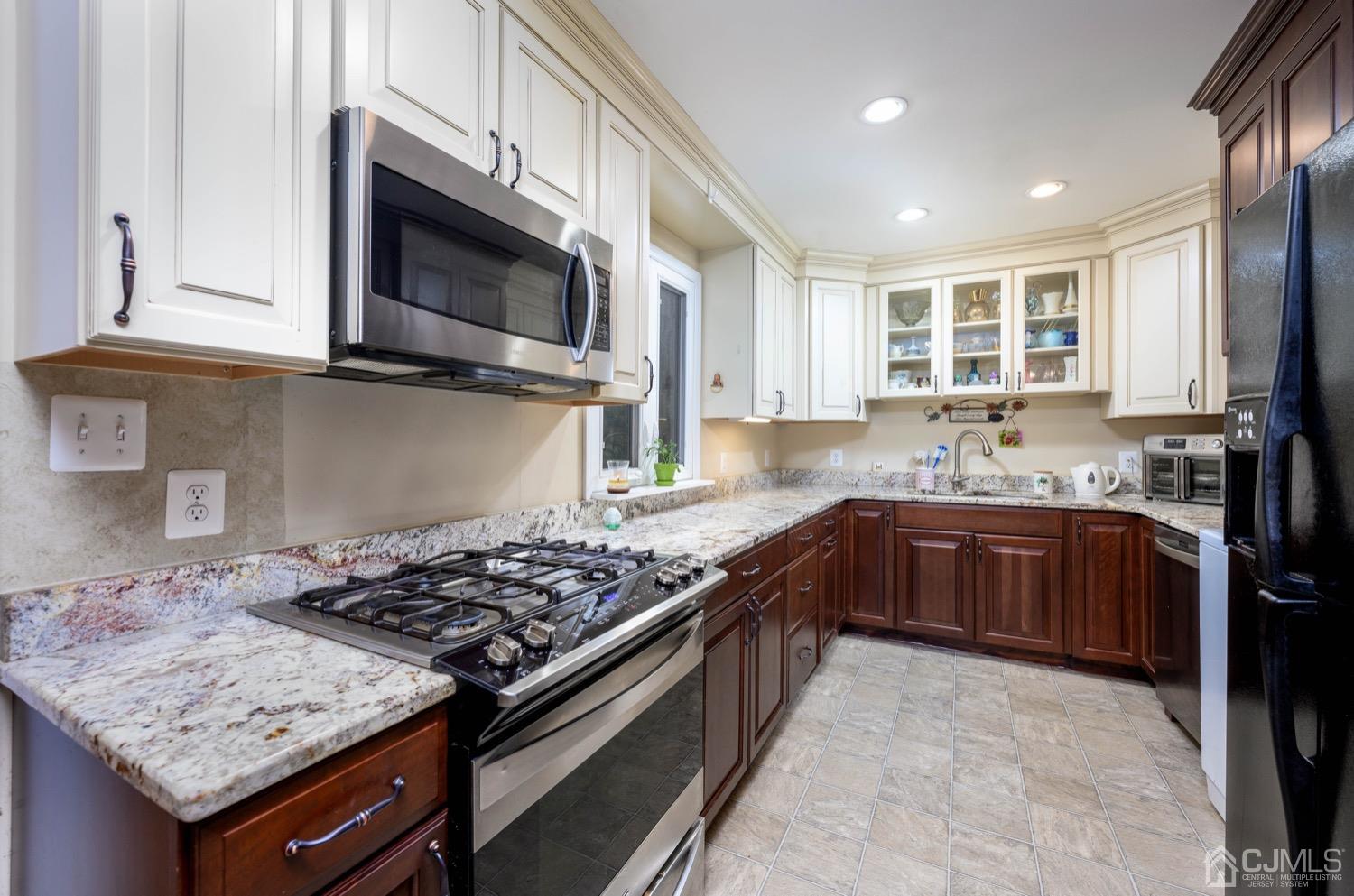 45 Stockton Road Kendall Park, NJ 08824 - Photo 10 of 30 a kitchen with stainless steel appliances granite countertop a stove and a microwave
