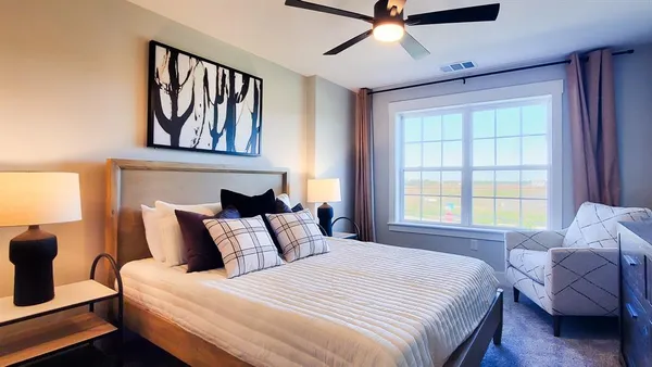 a bedroom with a bed and window