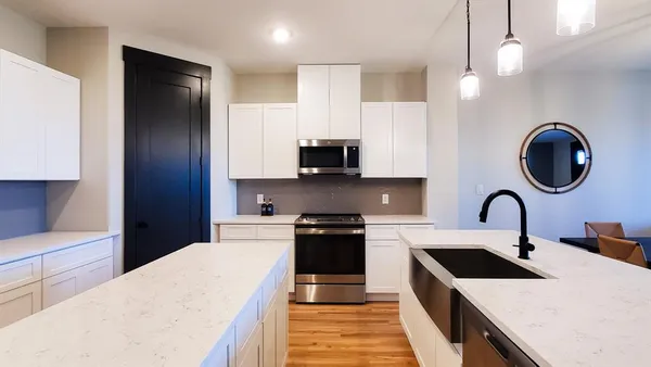 a kitchen with a sink a stove and refrigerator
