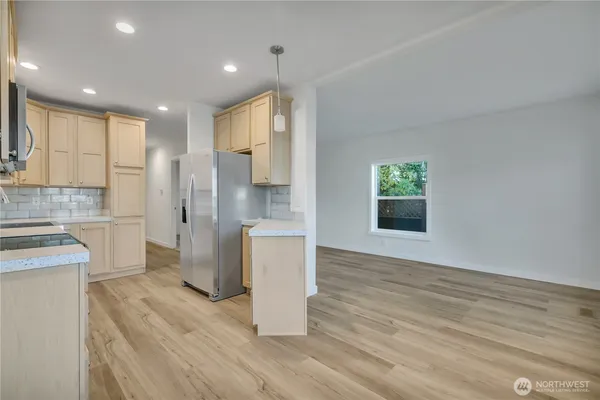 a view of a kitchen with a sink and a refrigerator