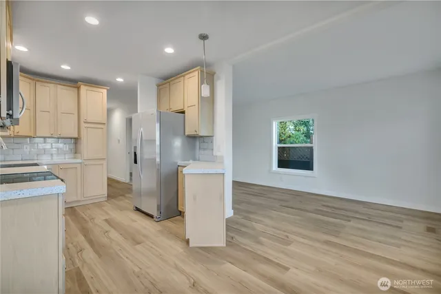 a view of a kitchen with a sink and a refrigerator