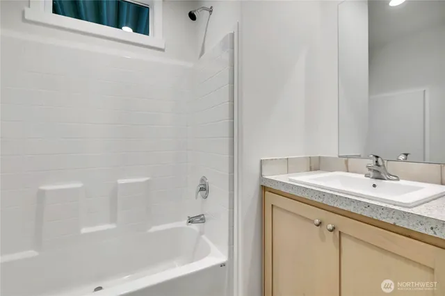 a bathroom with a granite countertop sink toilet and bathtub