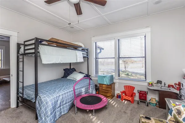 a bedroom with bed and a chandelier