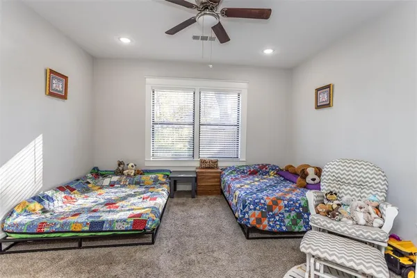 a bedroom with bed couch and window