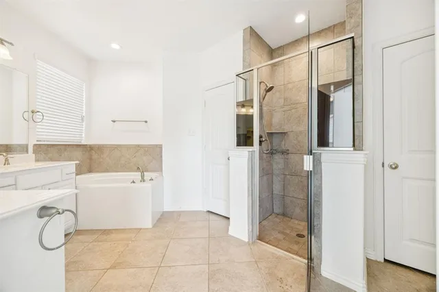 a bathroom with a granite countertop shower a sink and a mirror