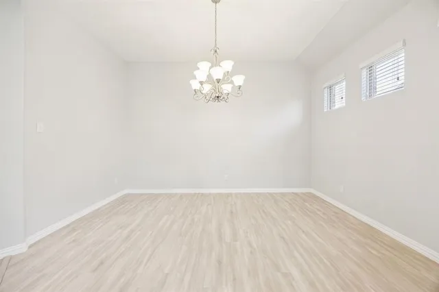 a view of a room with wooden floor and a ceiling fan
