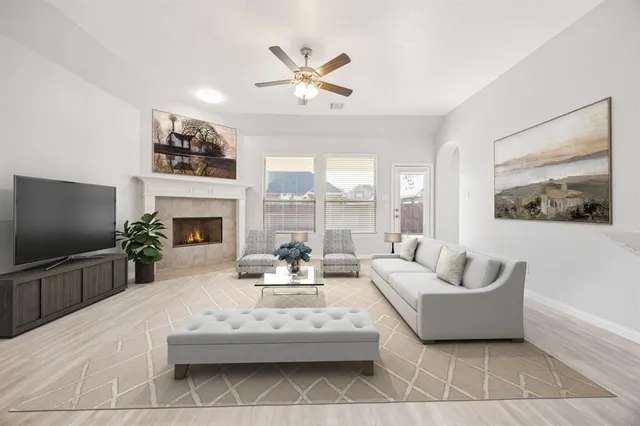 a living room with furniture a fireplace and a flat screen tv