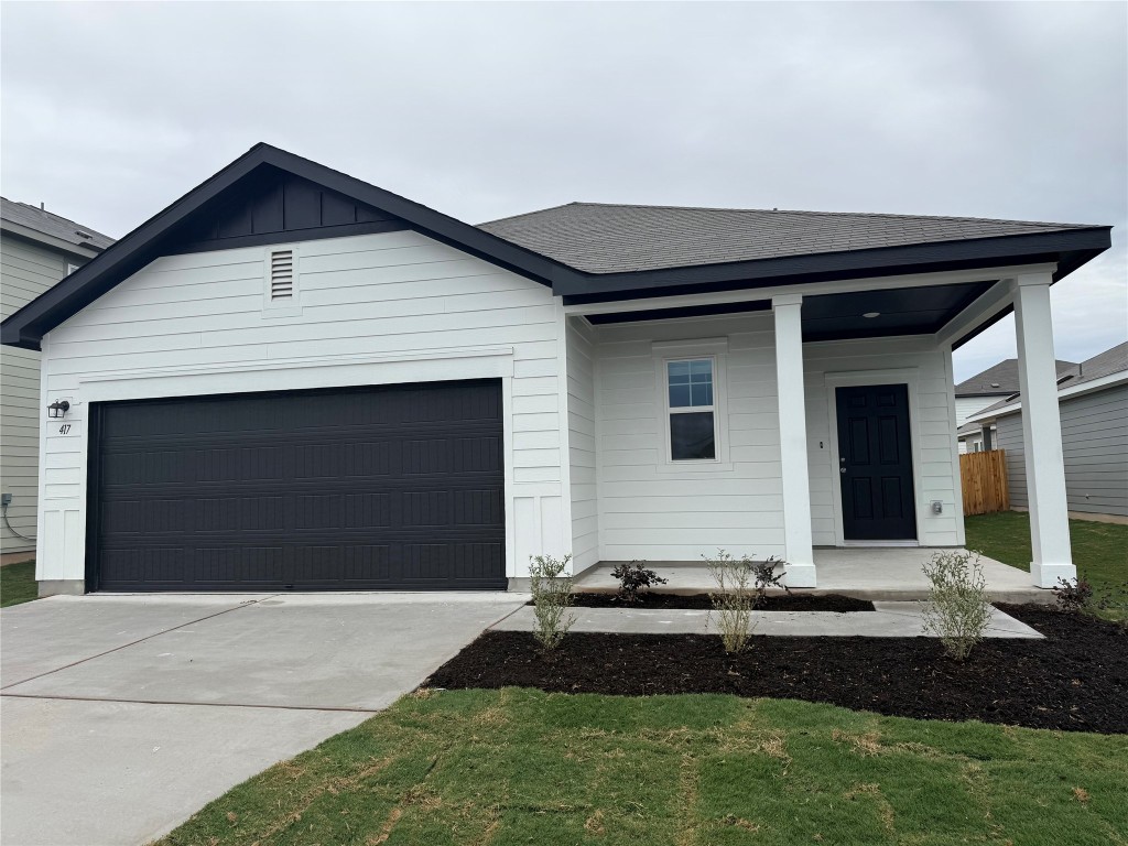 417 Wedemeyer Street Taylor, TX 76574 - Photo 2 of 15 a front view of a house with a yard