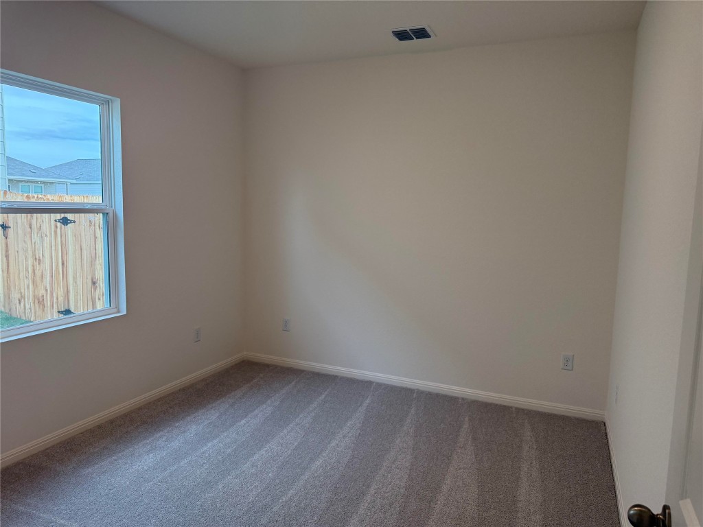 417 Wedemeyer Street Taylor, TX 76574 - Photo 10 of 15 a view of a small space with wooden floor and windows