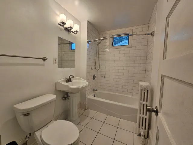 a bathroom with a toilet a sink and bathtub