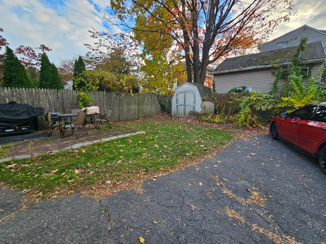 a view of a backyard with table and chairs and a fire pit