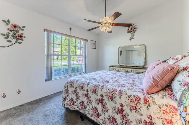 a dining room with couches a chandelier and a dining table with garden view