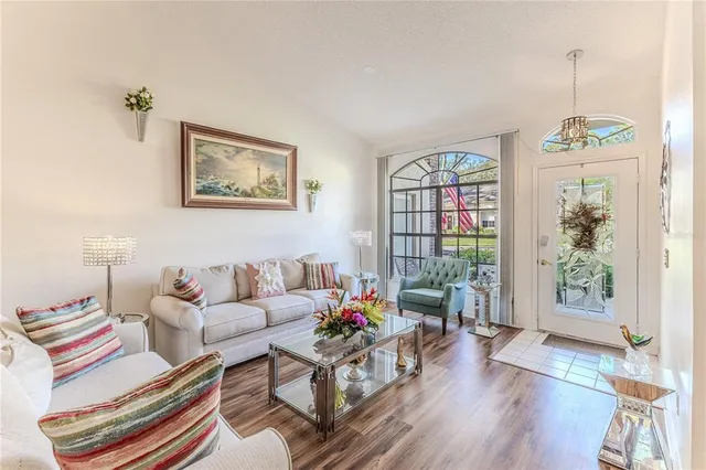 a living room with furniture and flowers