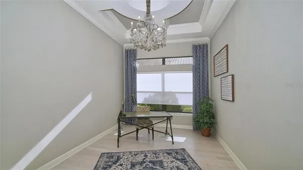 an open kitchen with granite countertop a sink and chandelier