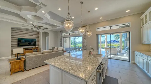 a bedroom with a large bed and a chandelier