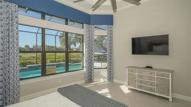 a dining room with furniture and a floor to ceiling window