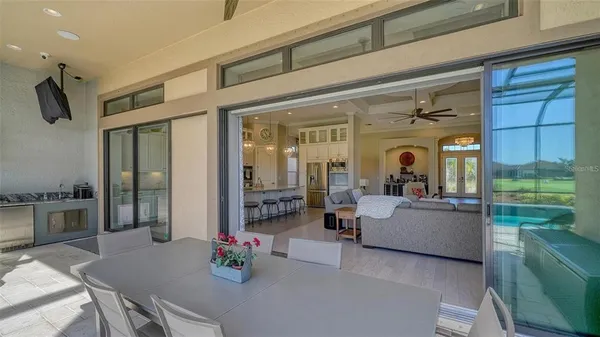 an aerial view of a swimming pool with a yard and lake view