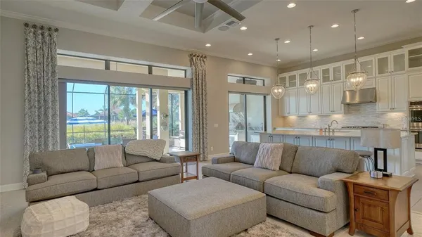 a dining room with furniture and a floor to ceiling window