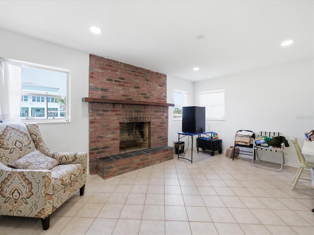 4069 Gulfview Drive Hernando Beach, FL 34607 - Photo 13 of 29 a living room with furniture and a fireplace