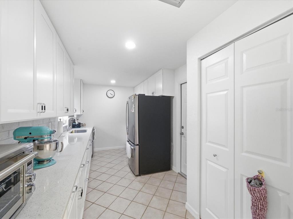 4069 Gulfview Drive Hernando Beach, FL 34607 - Photo 17 of 29 a living room with stainless steel appliances furniture and a refrigerator