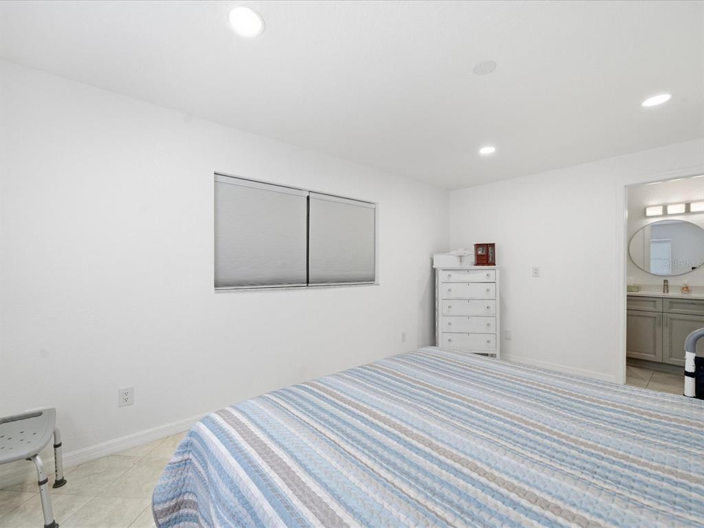 4069 Gulfview Drive Hernando Beach, FL 34607 - Photo 20 of 29 a bedroom with a bed and a view of bathroom
