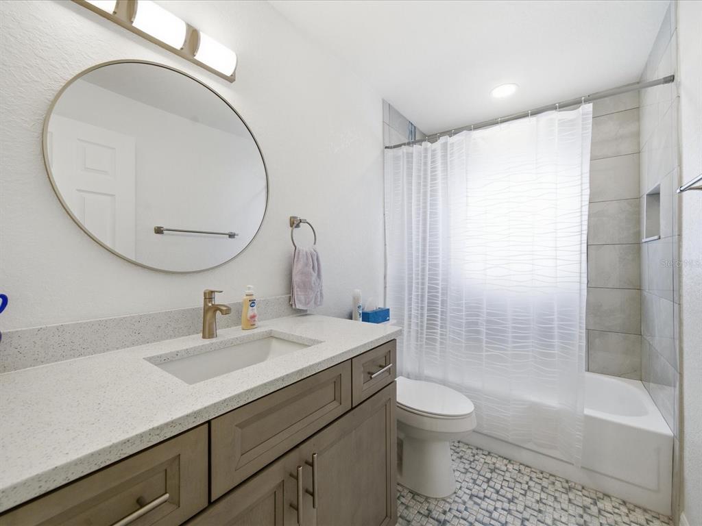 4069 Gulfview Drive Hernando Beach, FL 34607 - Photo 24 of 29 a bathroom with a sink a toilet and a mirror