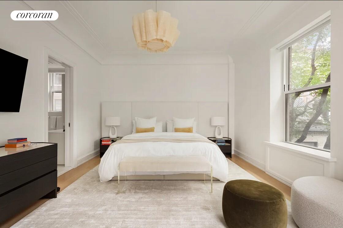 875 Park Avenue, Unit 4C Manhattan, NY 10075 - Photo 7 of 13 a bedroom with a bed and a flat screen tv