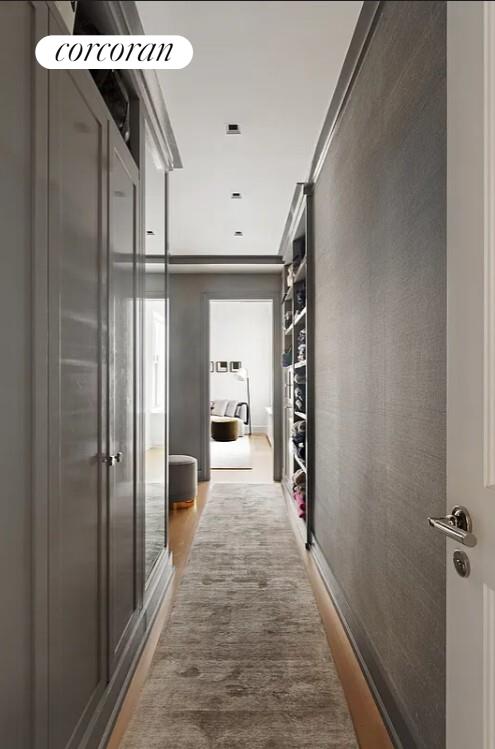 875 Park Avenue, Unit 4C Manhattan, NY 10075 - Photo 8 of 13 a hallway view with wooden floor and staircase