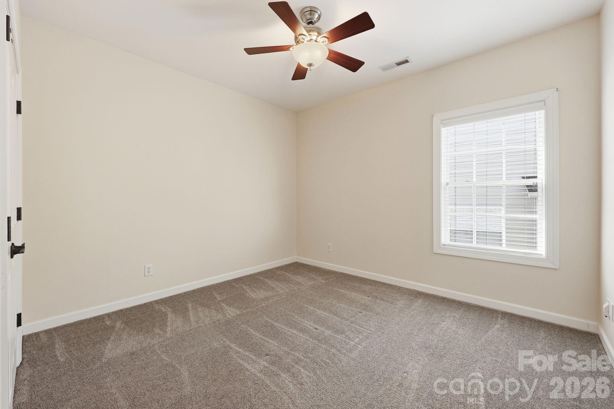 3308 Grandeur Road Charlotte, NC 28269 - Photo 28 of 45 an empty room with windows and fan
