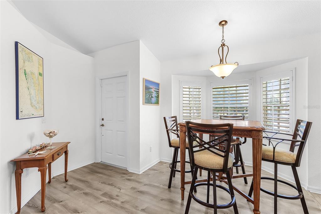 2031 Matecumbe Key Road Punta Gorda, FL 33955 - Photo 15 of 49 a view of a dining room with furniture window and wooden floor