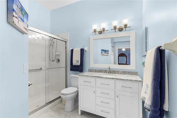 a bedroom with a bed and a ceiling fan