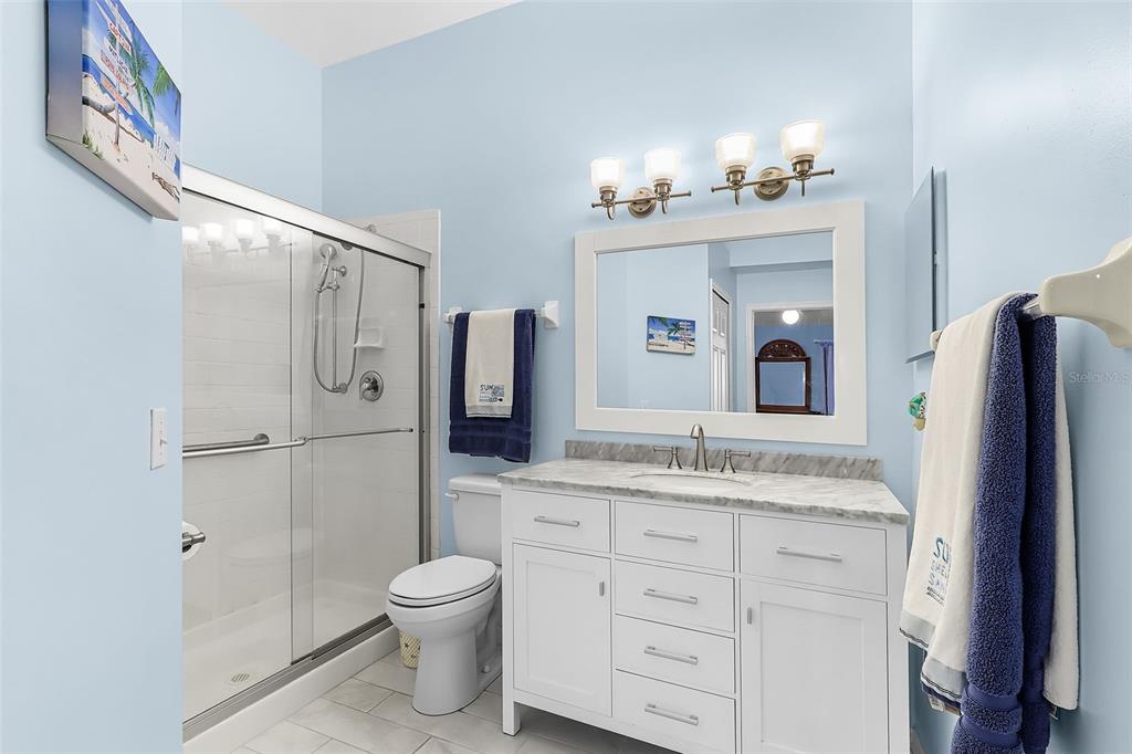 2031 Matecumbe Key Road Punta Gorda, FL 33955 - Photo 18 of 49 a bathroom with a granite countertop sink toilet and shower