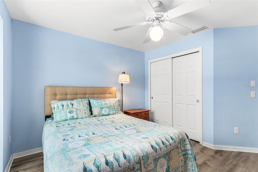 2031 Matecumbe Key Road Punta Gorda, FL 33955 - Photo 20 of 49 a bedroom with a bed and a ceiling fan